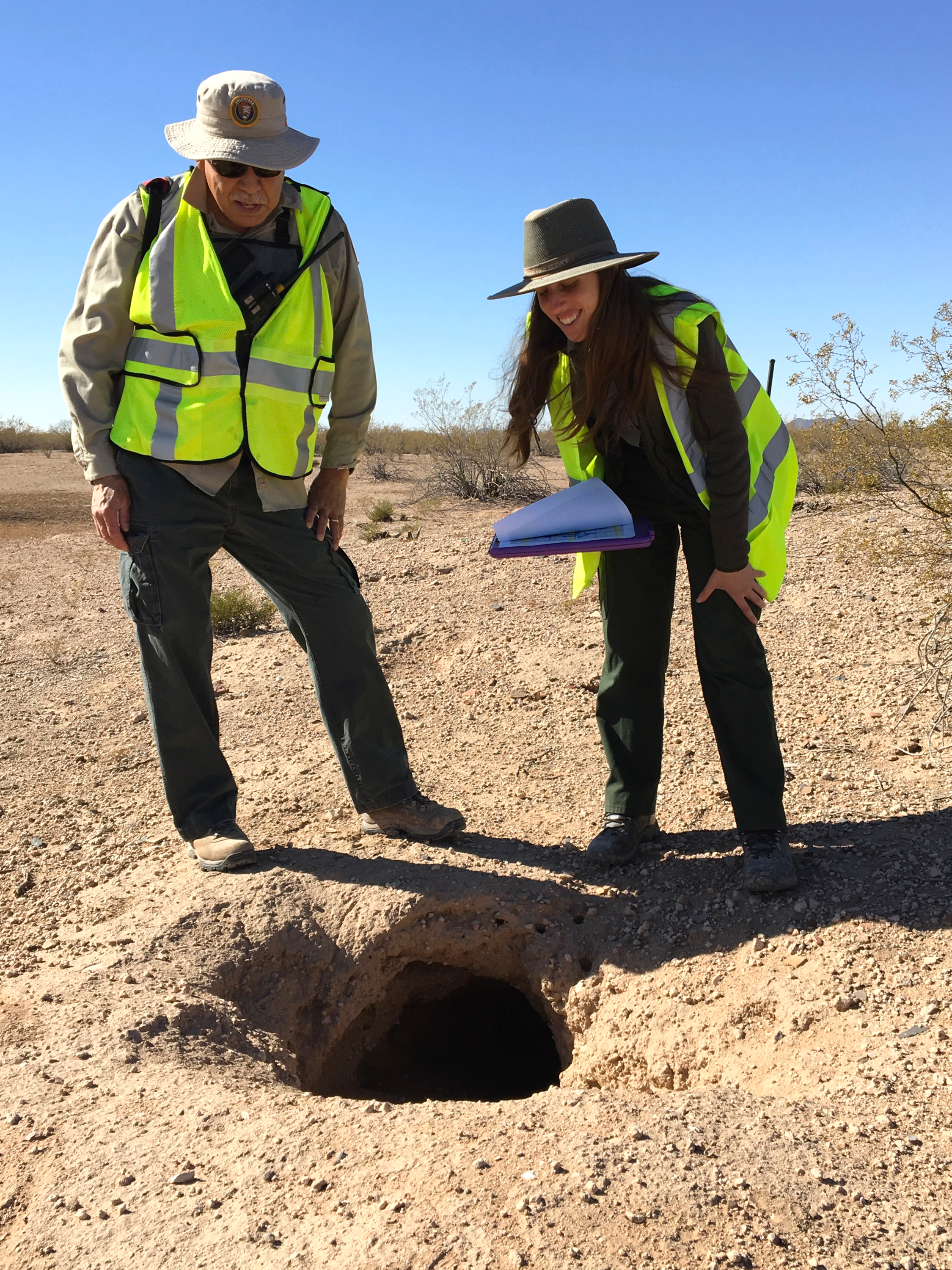 Mike Garcia and Katherine Shaum inspect a burrow