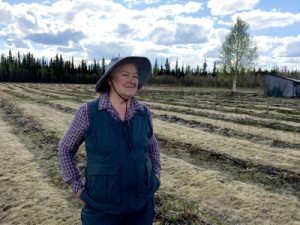 Marji Illingworth stands in front of a field.