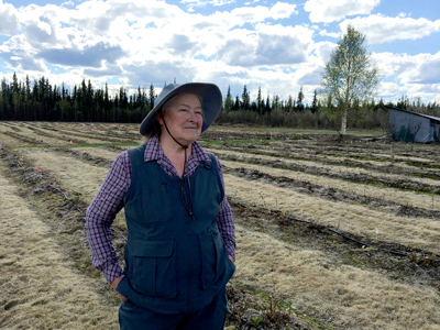 Marji Illingworth stands in front of a field.