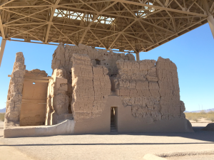 A large, ancient, mud building in the desert.