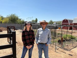 Naomi Pier and Ayman Mostafa stand in front of a small urban agriculture plot.